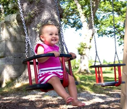 Baby on swing Stock Photos