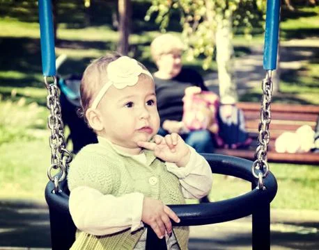 Baby on swing Stock Photos