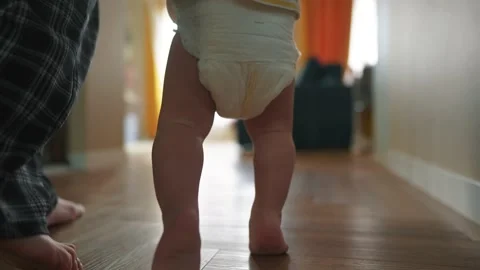Baby takes the first steps to learn. happy family kid dream concept. mom teaches Video stock 237078494