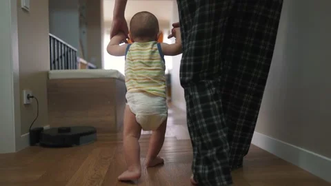 Baby takes the first steps to learn. happy family kid dream concept. mom teaches Stock Footage 238003236