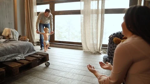 Baby taking first steps, child learning to walk Video stock 102339586