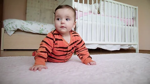 Baby in tiger clothes doing push ups Stock Footage 83611441
