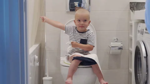 baby toddler sitting on toilet learning ... | Stock Video | Pond5