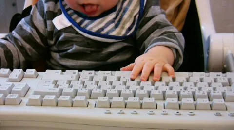 Baby typing on computer keyboard 2 Stock Footage 354496
