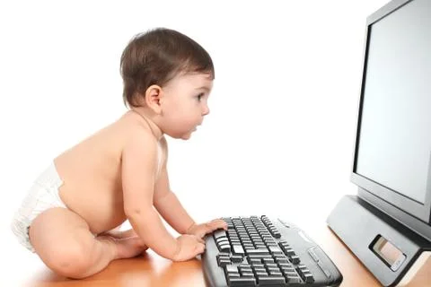Baby typing on a computer keyboard Stock Photos