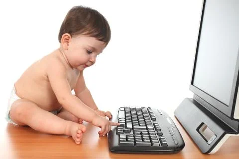 Baby typing on a computer keyboard Stock Photos