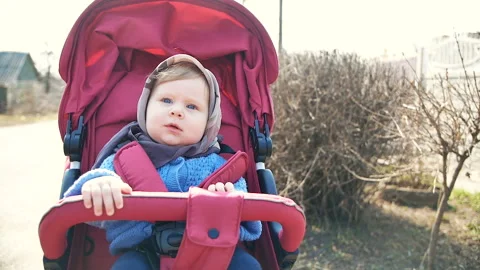 Baby on a walk in a stroller in the spring Stock Footage 88320759