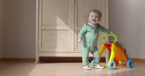 Baby walking alone without his helping toy Stock Footage 50146275