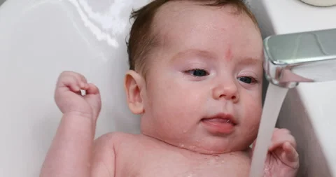A baby is washed in the sink Stock Footage 318023210