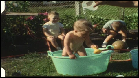 Baby in water tub (vintage 8 mm amateur film) Stock Footage