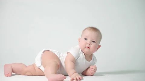 Baby on a white background does a back-to-back flip Stock Footage 235597280