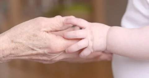 Babyhands touching senior hands 2 Video stock 47003580