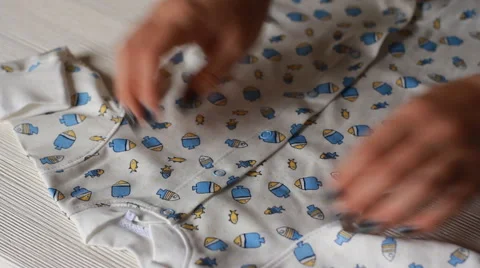 Baby's clothes on light background Stock Footage 56737103