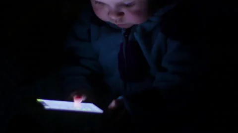 Baby's face illuminated by smartphone glow, 4K Stock Footage 47446878