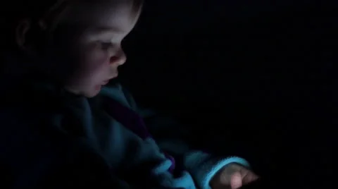 Baby's face illuminated by smartphone glow, 4K Stock Footage 47448238