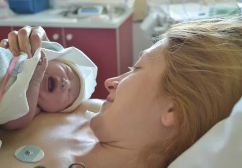 Baby's first cry. Mother and newborn after childbirth Stock Photos