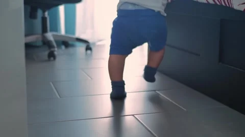 Baby's first steps. the child goes to take the first steps. happy family child Stock Footage 255968462