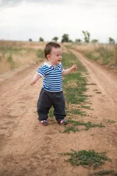 Baby's first steps in nature. The first independent steps. Stock Photos