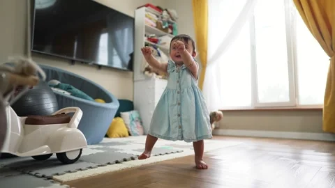 Baby's first steps. Toddler at home takes funny first steps. legs close-up. Baby Stock Footage 255239168