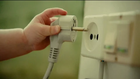 Baby's Hand insert elecrtic plug in wall socket Stock Footage 88795275