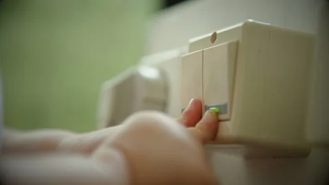 Baby's Hand plays with lelectric ight switch Stock Footage 88851932