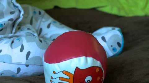 Baby's hand with red ball Видео 58372604