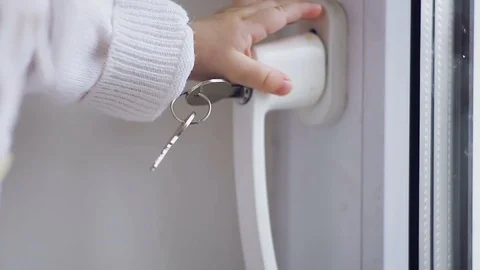 Baby's hands touch the keys in the door Stock Footage 98136699