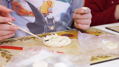 The baby's making figures out of the dough. Close-up Stock Footage 129813294