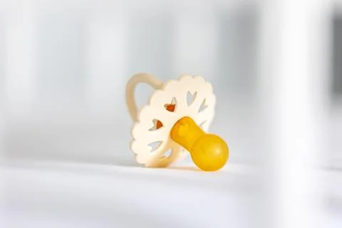 Baby's pacifier on a blurred white background. Stock Photos