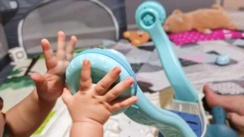 Baby's Playtime: Exploring the World Through Tiny Hands Stock Photos