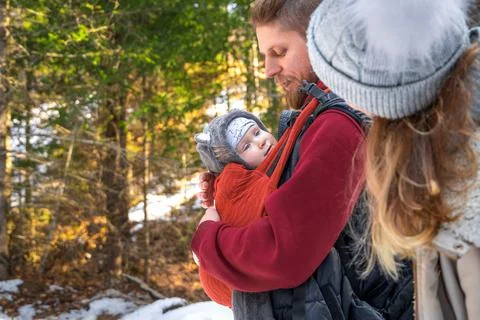 Babywearing winter walk of young parents with their children outdoor, copy space Stock Photos