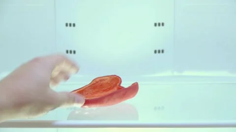 Bach takes away from the empty fridge last piece of sweet red pepper, close-up Stock Footage