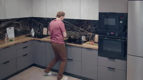 Bachelor dancing in the kitchen preparing his dinner Stock Footage 162863695