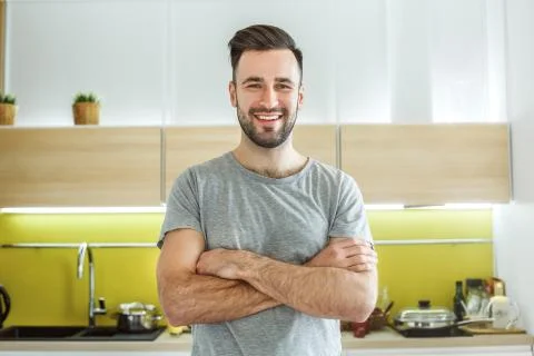 Bachelor man daily routine in the kitchen single lifestyle concept crossed arms Stock Photos