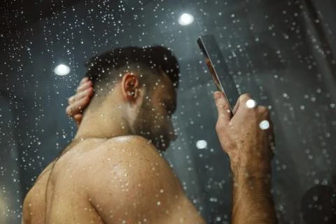 Bachelor man daily routine taking shower single lifestyle concept back view Stock Photos