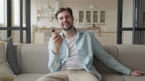 Bachelor Man Enjoy Weekends Resting Lean Sit on Comfy Sofa in Living Room Alone Stock Footage 299285153