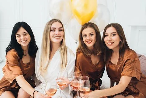 Bachelorette Weekend. bridesmaids posing into camera, they drinks alcohol and Stockfoto's