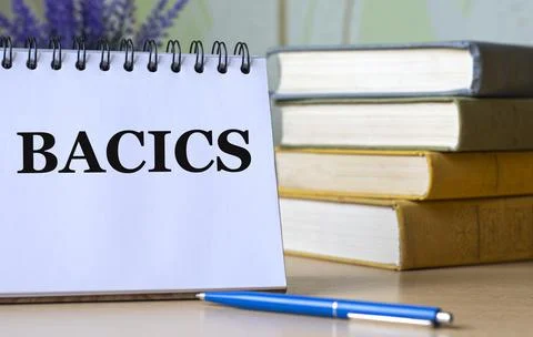 BACICS - a word in a notebook against the background of old books with a pen Stock Photos