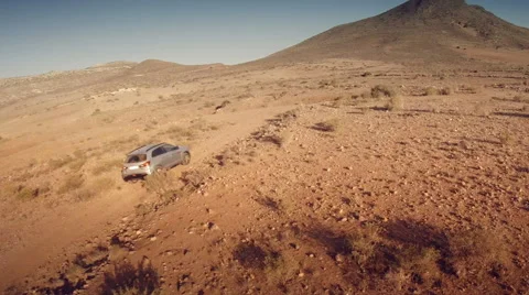 Back aerial view of a 4 by 4 car through the desert. Spain. Stock Footage 47327061