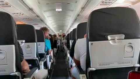 Back of airplane interior. passenger perspective in plane corridor Stock Footage 154964827