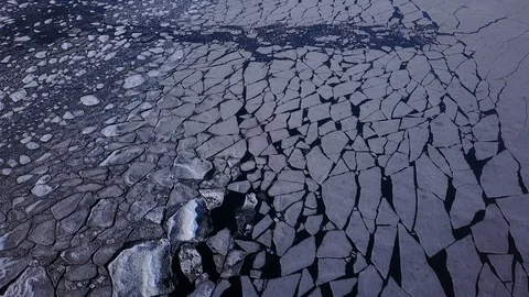 Back and down aerial view of cracked ice with sunset light Stock Footage 94134863