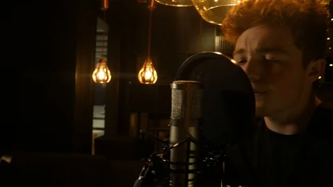 Back and Forth Pan shot of a Male Singer at a small intimate venue singing into Stock Footage 89813830