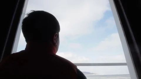 The back and the neck of the boy looking out the window on the ferry Stock Footage 76455461