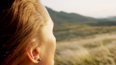 Back and side view slow motion close up portrait in profile a woman admires a Stock Footage 241650566