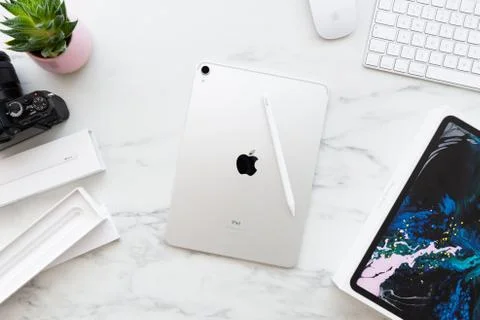The back of the Apple iPad Pro 11 inch with Apple Pencil 2 on white marble ba Stock Photos