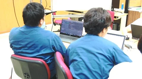 Back of Asian computer engineering student working on computer programming Stock Footage 107372537