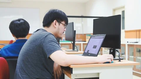 Back of Asian computer engineering student working on computer programming Video stock 107372631