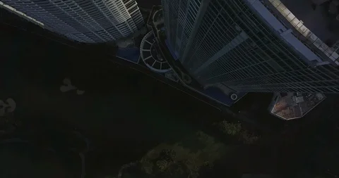 Back away aerial flight of high rise building tilting up revealing city. Stock-Footage 130159635