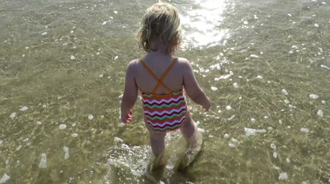 Back of baby walking in ocean Stock Footage 58260212