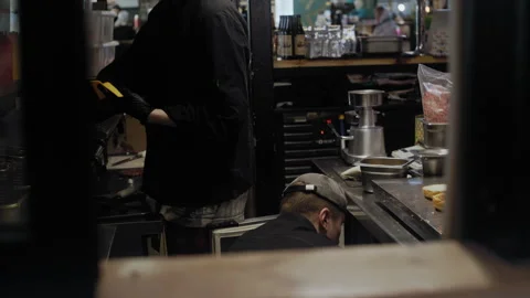 Back-to-Back Chefs Preparing Fast Food in Sync Stockbeeldmateriaal 307075269